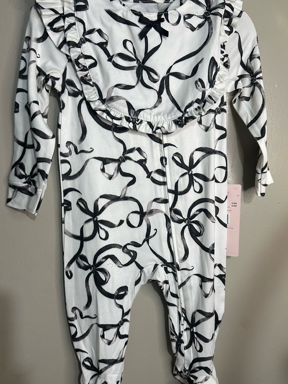 Paris Hilton White Footed One-Piece with Black Ribbon Bow Print and Ruffle Bib